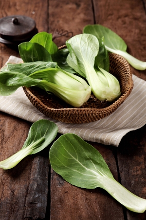 Pak choi on table and in basketの写真素材