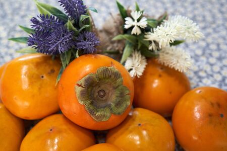 Delicious winter fruits, sweet persimmons on whiteの写真素材