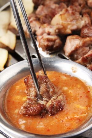 Grilled pork dipped in sauceの写真素材