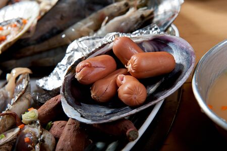 Raw sausage and seafood on plate