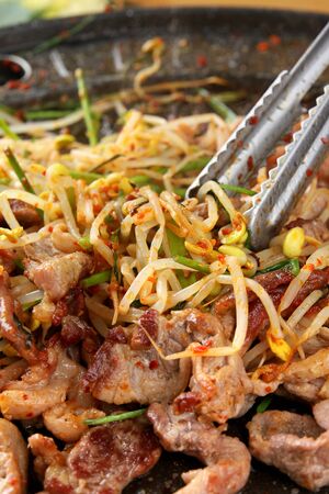 Grilled pork with seasoned bean sprouts on grillの写真素材