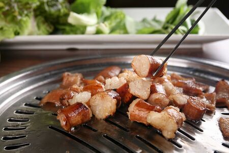 Grilled tripes being grabbed with chopsticksの写真素材