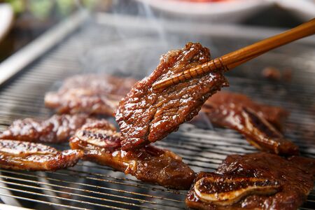 Chopsticks grabbing grilled short ribsの写真素材