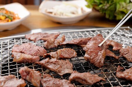 Grilledprime ribs grabbed with chopsticksの写真素材