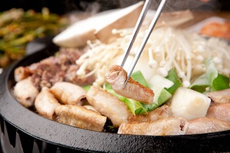Chopsticks grabbing grilled entrailsの写真素材