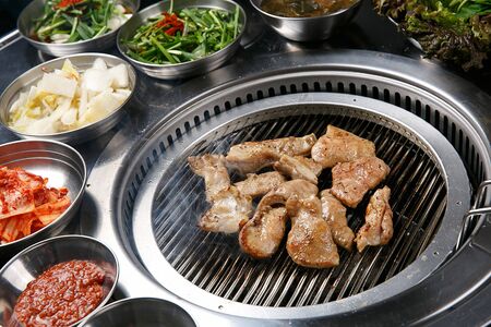 Grilled intestines on grill with side dishesの写真素材