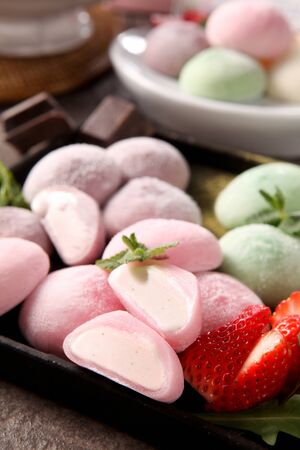 Half sliced pink, light purple, light green mocchi rice cakesの写真素材