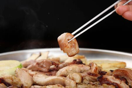 Chopsticks grabbing grilled entrailsの写真素材