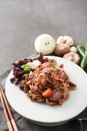 Duck Meat fried with vegetablees and glass noodles on round plateの写真素材