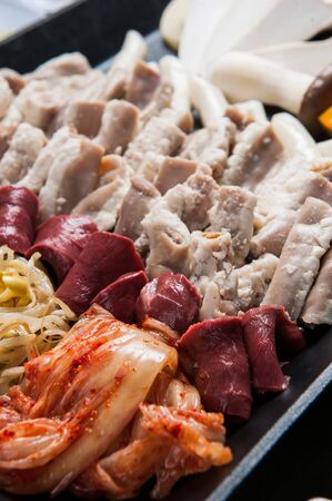 Vegetable mix and uncooked entrail assortment on plateの写真素材