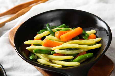 Garnish with carrots and asparagus on frying pan