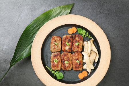 Grilled Korean short rib patty with vegetables and mushrooms on grillの写真素材