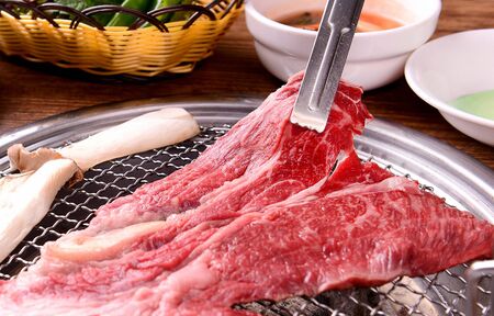 raw sirloin and mushrooms on grillの写真素材