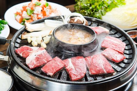 sirloin slices, mushrooms, garlic and bean paste stew on grillの写真素材