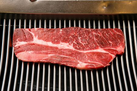 raw sirloin on grillの写真素材