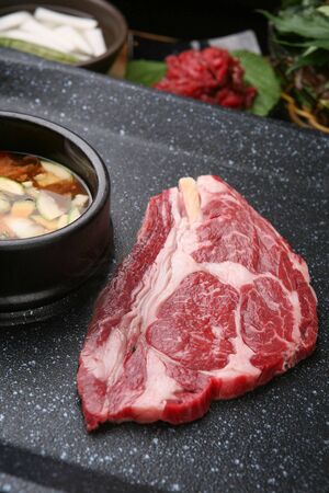 raw meat and bean paste stew on grillの写真素材