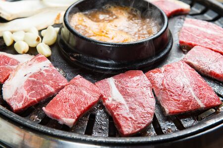 sirloin slices, mushrooms, garlic and bean paste stew on grillの写真素材