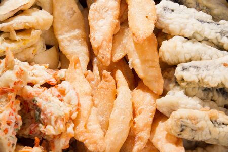 various fried food such as dumplings, glass noodles and seaweed, vegetables and sweet potatoesの写真素材