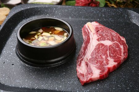 raw chunk of sirloin on grill with bean paste stewの写真素材