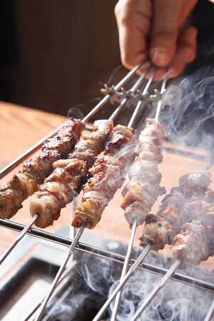 hand grabbing lamb skewersの写真素材