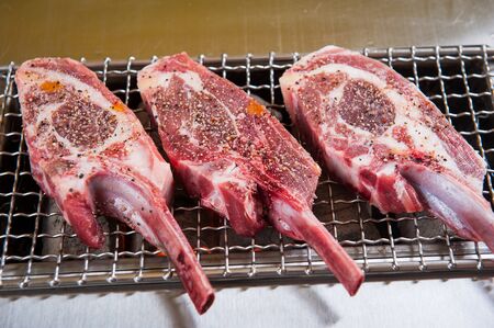 raw lamb chops on grillの写真素材