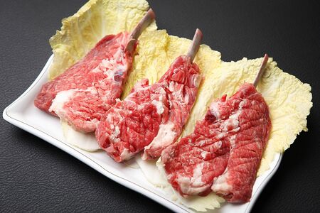 raw lamb chops on cabbageの写真素材