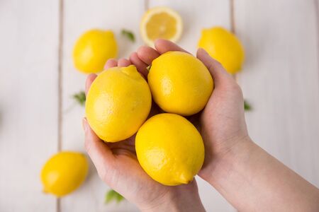 Fresh citrus fruit lemon on handsの写真素材