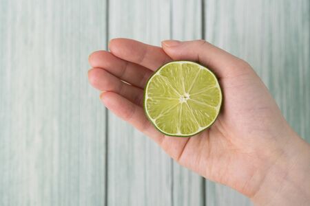 Fresh citrus fruit lime on handの写真素材