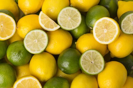 Fresh citrus fruit lemons and limes backgroundの写真素材