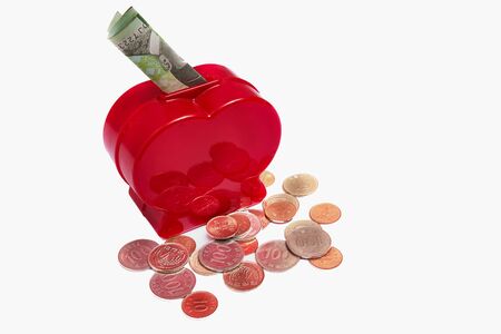 Concept of love and saving money. money box in heart shape with money.の写真素材