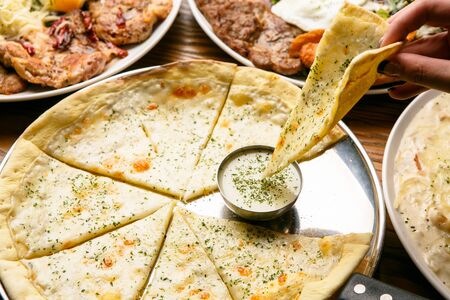 slice of gorgonzola pizza dipped in sauce