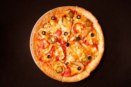 combination pizza on white plateの写真素材