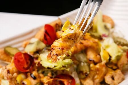 cajun chicken salad grabbed with forkの写真素材