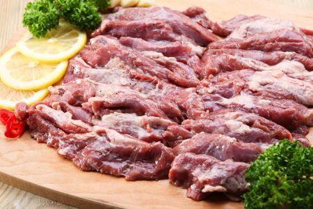 raw beef ribs for barbecue on wood plate
