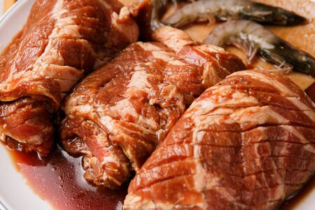 raw seasoned pork, shrimp and pork skin on plate, Korean barbecueの写真素材