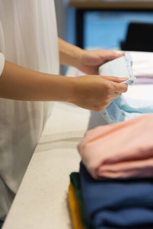 Single life concept, washing clothes at laundromat