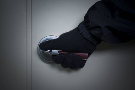 Criminal concept photo, Male Thief open the doorの写真素材