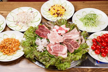 A collection of raw beef and pork from various parts on plateの写真素材