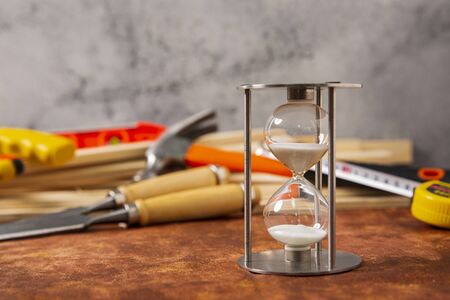 Sand glass and Hand work tools or construction tools top view