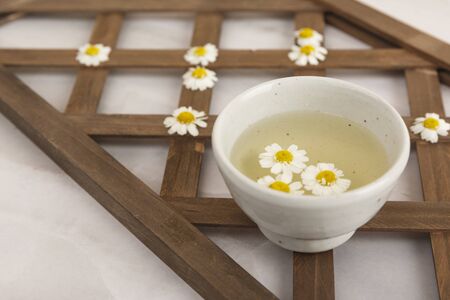 Water bowl with white chrysanthemum flowersの写真素材