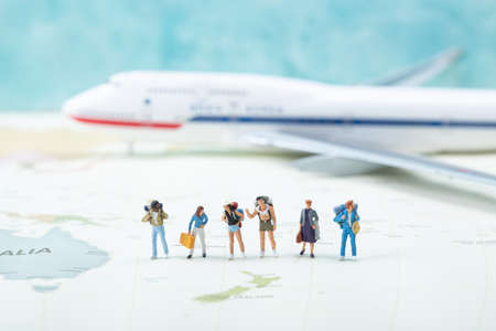 Miniature world concept- Miniature figurine of traveler, businessman, couple, familyの写真素材