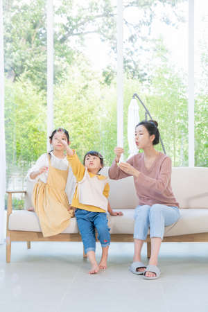 Portrait of happy cheerful family, young mother and two daughters 085の写真素材