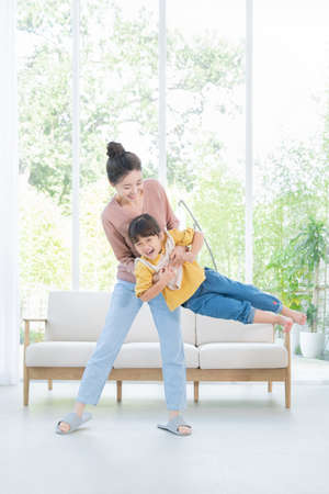 Portrait of happy cheerful family, young mother and two daughters 070の写真素材