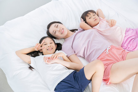 Portrait of happy cheerful family, young mother and two daughters 421の写真素材