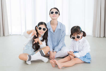 Portrait of happy cheerful family, young mother and two daughters 377の写真素材