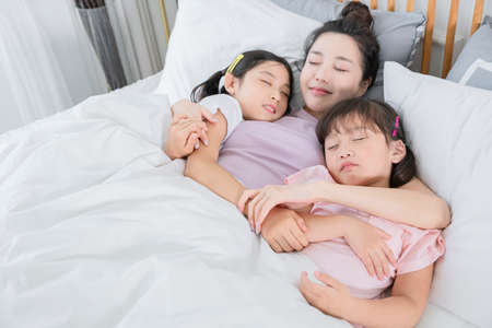 Portrait of happy cheerful family, young mother and two daughters 460の写真素材