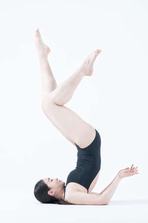contemporary Asian female dancer making move in white background