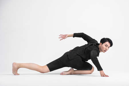 contemporary asian male dancer making move in white background