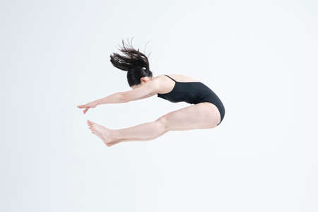 contemporary Asian female dancer making move in white background