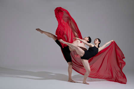 male and female couple modern contemporary dancers making moves in white background setting